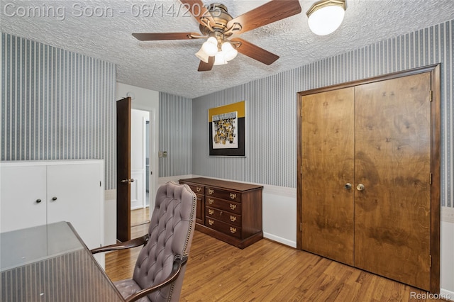 5614 Warbler Dr, Clarkston, MI 48346 - office space featuring wallpapered walls, light wood-type flooring, a textured ceiling, and a ceiling fan