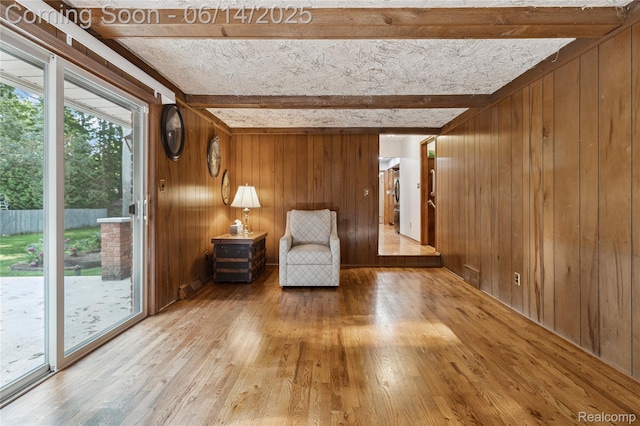 5614 Warbler Dr, Clarkston, MI 48346 - sitting room with beam ceiling, wood walls, and wood-type flooring