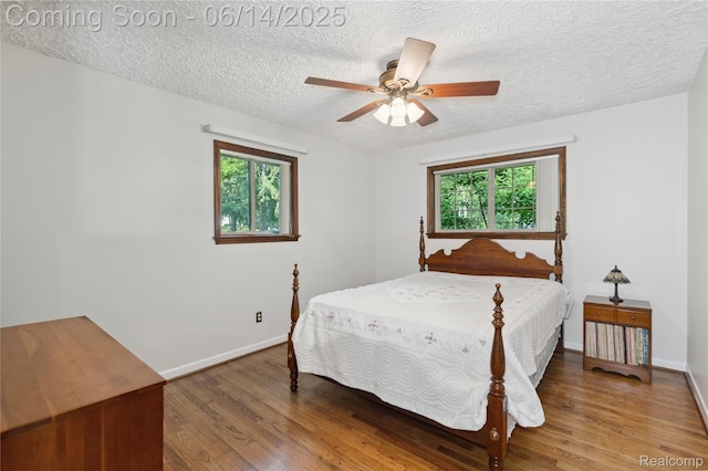 5614 Warbler Dr, Clarkston, MI 48346 - bedroom featuring a textured ceiling, wood finished floors, and a ceiling fan