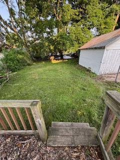 313 Morse St, Ionia, MI 48846 - view of grassy yard featuring an outdoor structure