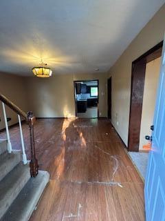 313 Morse St, Ionia, MI 48846 - corridor featuring wood finished floors and stairs