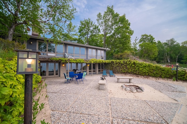 3524 Lakeshore Rd, Manistee, MI 49660 - view of patio with a fire pit, french doors, a wooden deck, and outdoor dining area