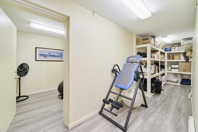 3524 Lakeshore Rd, Manistee, MI 49660 - workout area featuring wood finished floors and a baseboard radiator