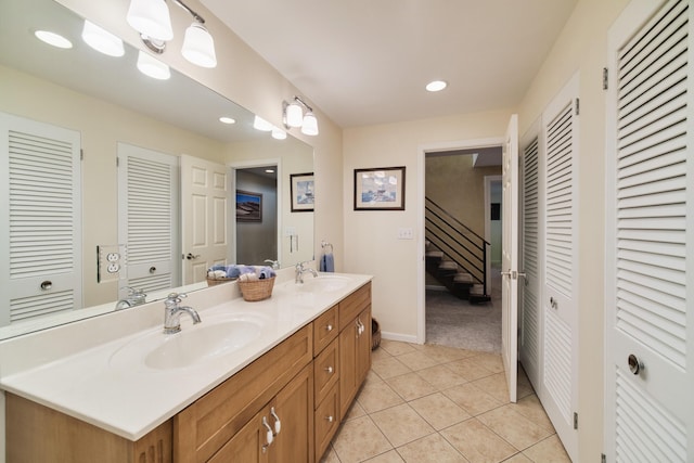 3524 Lakeshore Rd, Manistee, MI 49660 - bathroom with a closet, double vanity, tile patterned floors, and recessed lighting