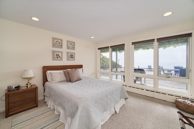3524 Lakeshore Rd, Manistee, MI 49660 - bedroom with baseboard heating, light colored carpet, recessed lighting, and access to exterior
