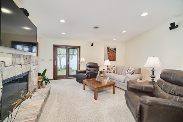 3524 Lakeshore Rd, Manistee, MI 49660 - living area featuring light carpet, recessed lighting, and a stone fireplace
