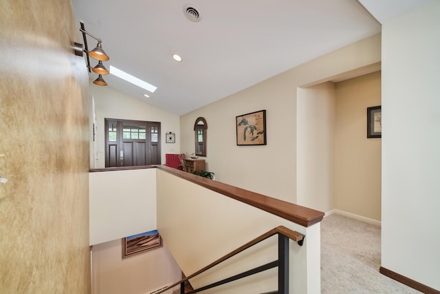 3524 Lakeshore Rd, Manistee, MI 49660 - corridor featuring a skylight, vaulted ceiling, carpet flooring, an upstairs landing, and recessed lighting