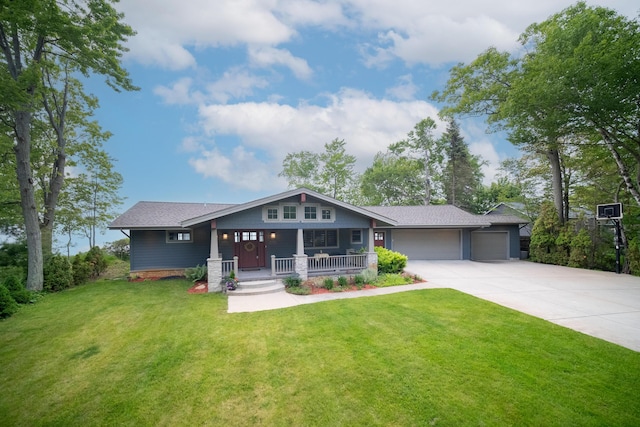 3524 Lakeshore Rd, Manistee, MI 49660 - craftsman-style house featuring a porch, a garage, concrete driveway, a front yard, and roof with shingles