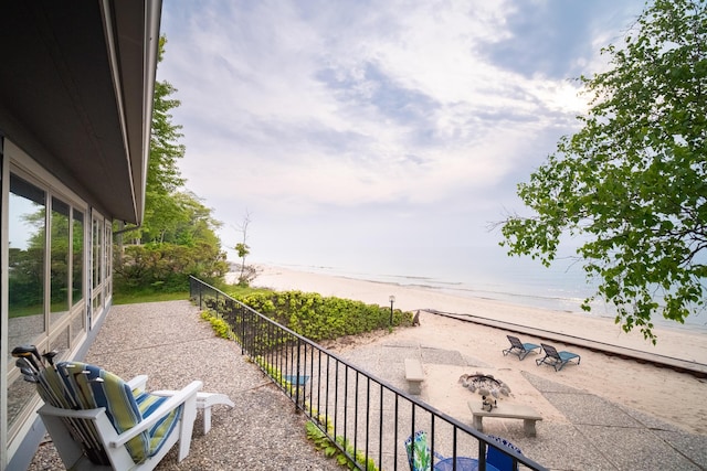 3524 Lakeshore Rd, Manistee, MI 49660 - balcony with view of water and beach and a fire pit
