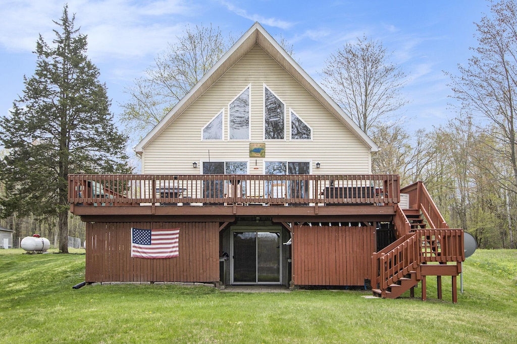 3133 Minkler Lake Rd, Allegan, MI 49010 - rear view of house featuring stairs, a deck, and a yard