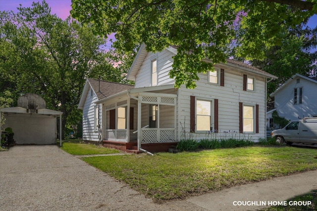 610 S Park St, Hastings, MI 49058 - view of front of property featuring a front yard, roof with shingles, and a sunroom