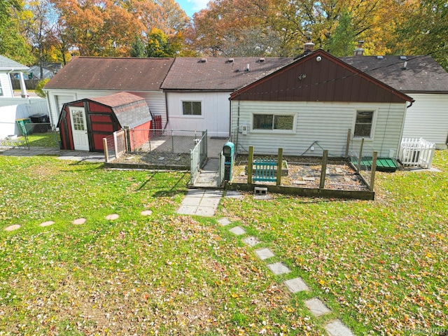 33566 Rhonswood St, Farmington Hills, MI 48335 - back of property featuring a fenced backyard, a gate, a storage shed, and a garden