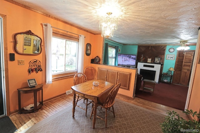 33566 Rhonswood St, Farmington Hills, MI 48335 - dining space with dark wood-style floors, healthy amount of natural light, crown molding, a chandelier, and a ceiling fan