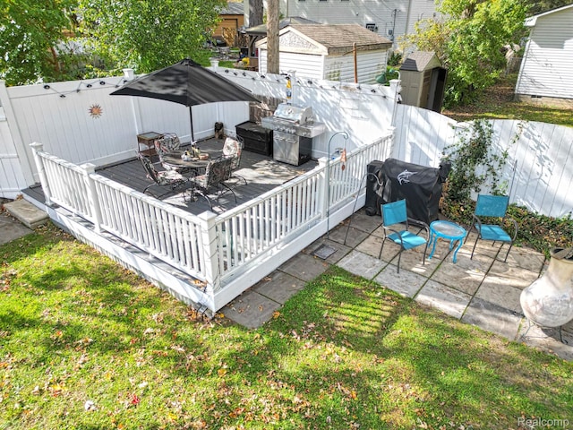 33566 Rhonswood St, Farmington Hills, MI 48335 - wooden deck with area for grilling, a fenced backyard, and a shed