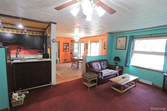 33566 Rhonswood St, Farmington Hills, MI 48335 - living area with a ceiling fan, a chandelier, and dark carpet