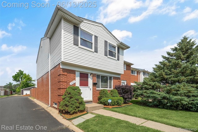 20107 Merle Ct, Eastpointe, MI 48035 - view of front of home with brick siding, a front yard, and an outbuilding