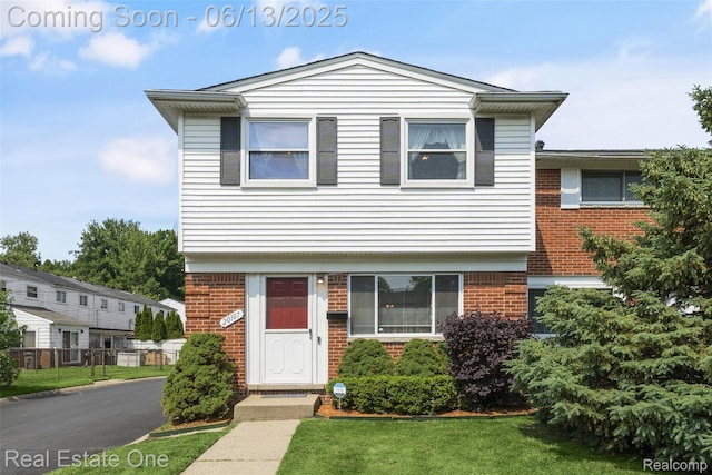20107 Merle Ct, Eastpointe, MI 48035 - view of front facade featuring brick siding and a front yard