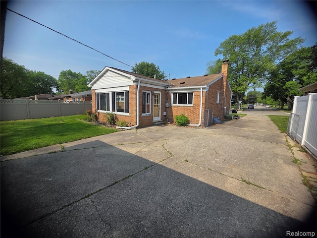 9990 Hambleton St, Canton, MI 48150 - back of house featuring brick siding and a chimney