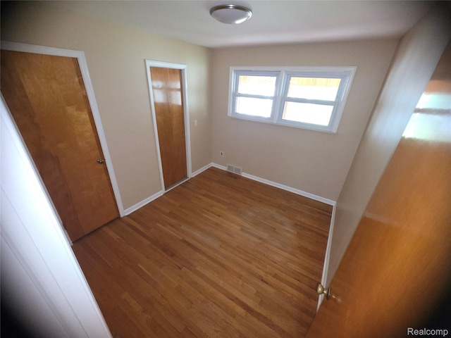 9990 Hambleton St, Canton, MI 48150 - unfurnished bedroom with wood finished floors and baseboards