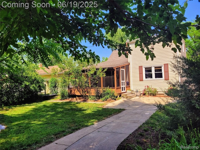 1118 Pine St, Grand Ledge, MI 48837 - view of front of home featuring a sunroom, a front yard, and roof with shingles