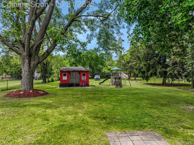 10997 Stark Rd, Livonia, MI 48150 - view of yard with a playground, a storage unit, and view of scattered trees