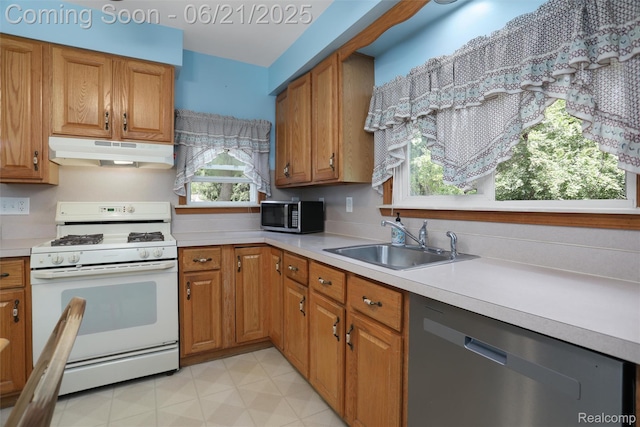 10997 Stark Rd, Livonia, MI 48150 - kitchen featuring appliances with stainless steel finishes, under cabinet range hood, brown cabinetry, and light countertops
