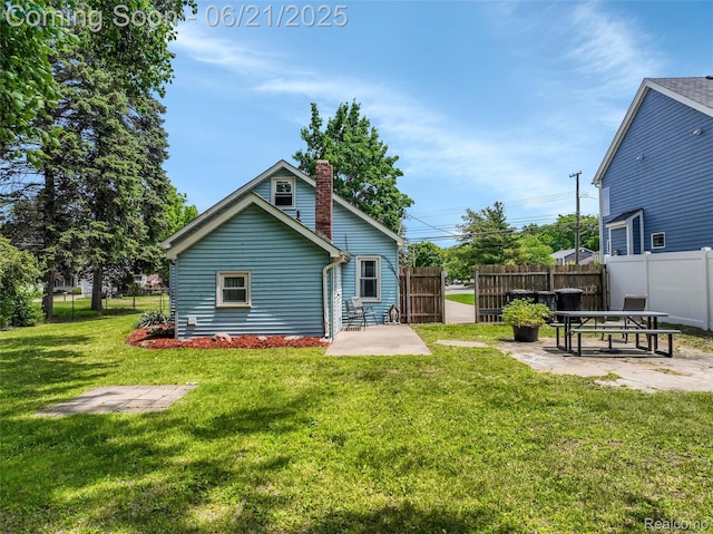 10997 Stark Rd, Livonia, MI 48150 - back of property with a patio area and a chimney