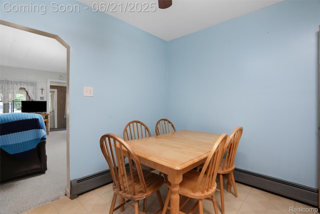 10997 Stark Rd, Livonia, MI 48150 - dining space with a baseboard radiator, a ceiling fan, light floors, and arched walkways