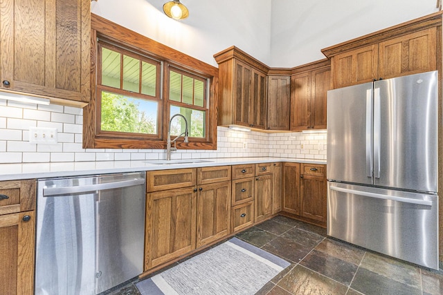 3778 22nd St, Dorr, MI 49323 - kitchen featuring appliances with stainless steel finishes, stone tile flooring, light countertops, and brown cabinets