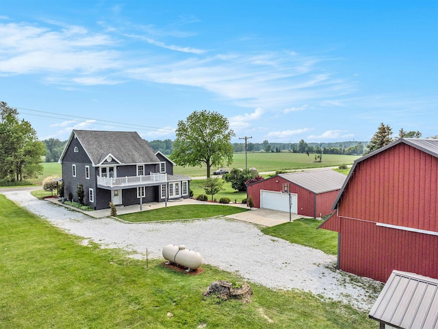 598 Dayburg Rd, Coldwater, MI 49036 - view of side of property featuring driveway, an outbuilding, a yard, and a garage