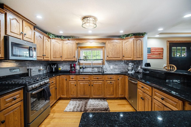 598 Dayburg Rd, Coldwater, MI 49036 - kitchen with stainless steel appliances, dark stone counters, light wood-style flooring, decorative backsplash, and recessed lighting
