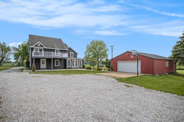 598 Dayburg Rd, Coldwater, MI 49036 - view of front of home featuring an outbuilding, a front lawn, a garage, and gravel driveway
