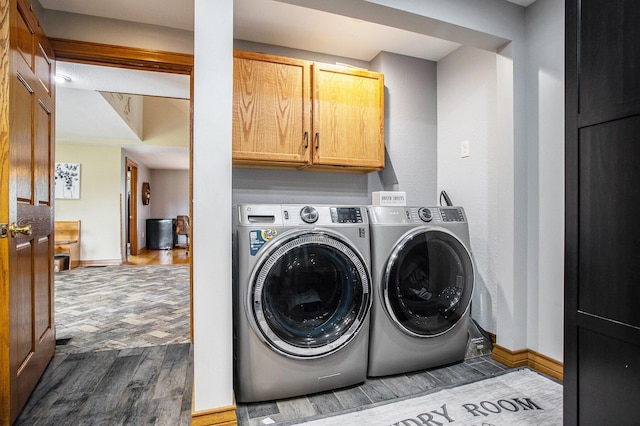 598 Dayburg Rd, Coldwater, MI 49036 - laundry area with dark wood-type flooring, cabinet space, and separate washer and dryer