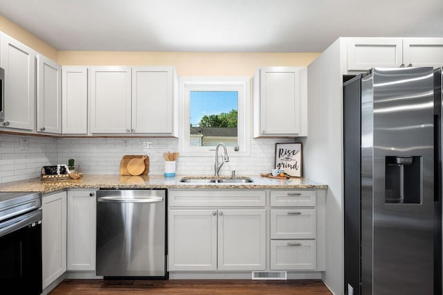 310 Hillview St, Buchanan, MI 49107 - kitchen featuring appliances with stainless steel finishes, tasteful backsplash, and light stone counters