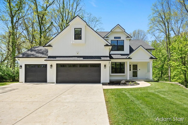 3980 Hathaway Rd, Kalamazoo, MI 49009 - modern farmhouse with a shingled roof, a front lawn, driveway, and a garage