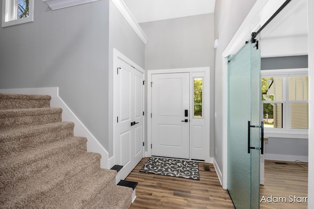 3980 Hathaway Rd, Kalamazoo, MI 49009 - entrance foyer with wood finished floors, stairs, plenty of natural light, and a barn door