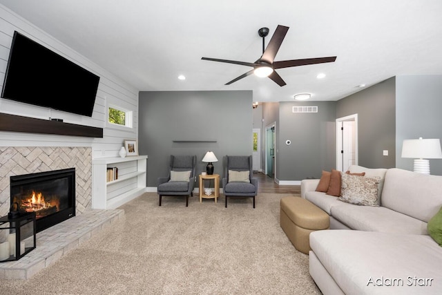 3980 Hathaway Rd, Kalamazoo, MI 49009 - carpeted living area featuring a tiled fireplace, recessed lighting, and ceiling fan