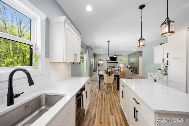 3980 Hathaway Rd, Kalamazoo, MI 49009 - kitchen featuring decorative backsplash, open floor plan, wood finished floors, white cabinets, and recessed lighting
