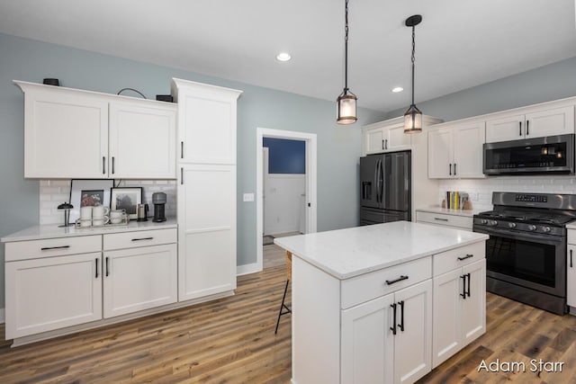 3980 Hathaway Rd, Kalamazoo, MI 49009 - kitchen featuring appliances with stainless steel finishes, decorative backsplash, white cabinets, recessed lighting, and pendant lighting