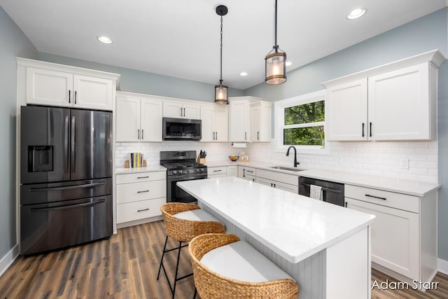 3980 Hathaway Rd, Kalamazoo, MI 49009 - kitchen featuring appliances with stainless steel finishes, white cabinets, dark wood-style floors, decorative backsplash, and recessed lighting