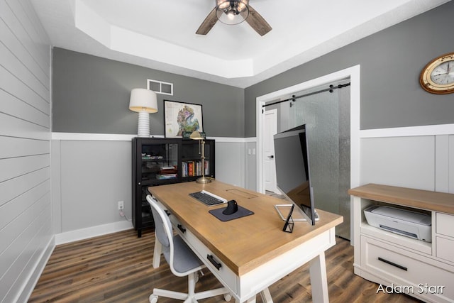 3980 Hathaway Rd, Kalamazoo, MI 49009 - office space featuring a tray ceiling, ceiling fan, dark wood-type flooring, wood walls, and a barn door