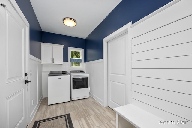 3980 Hathaway Rd, Kalamazoo, MI 49009 - washroom featuring washer and clothes dryer, cabinet space, and wainscoting