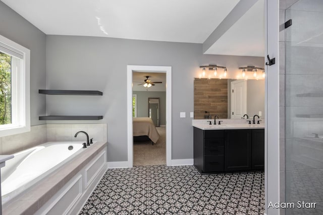 3980 Hathaway Rd, Kalamazoo, MI 49009 - ensuite bathroom featuring double vanity, a garden tub, a ceiling fan, and a tile shower