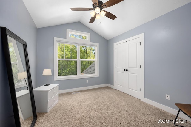 3980 Hathaway Rd, Kalamazoo, MI 49009 - unfurnished bedroom featuring vaulted ceiling, light colored carpet, a closet, and a ceiling fan