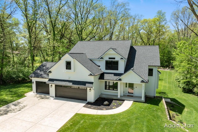3980 Hathaway Rd, Kalamazoo, MI 49009 - modern inspired farmhouse featuring roof with shingles, concrete driveway, a front yard, and a porch