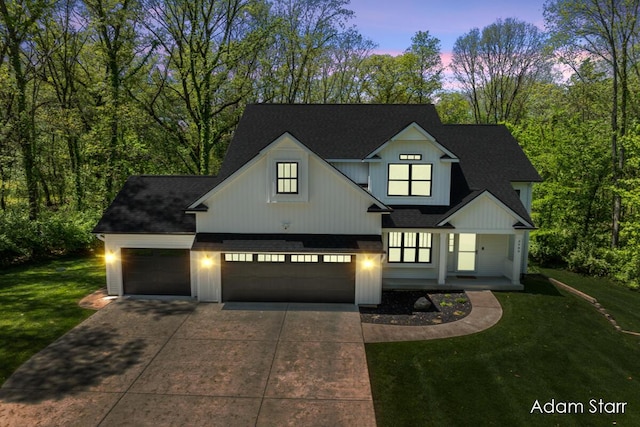 3980 Hathaway Rd, Kalamazoo, MI 49009 - modern farmhouse style home with roof with shingles, a front lawn, concrete driveway, and a garage