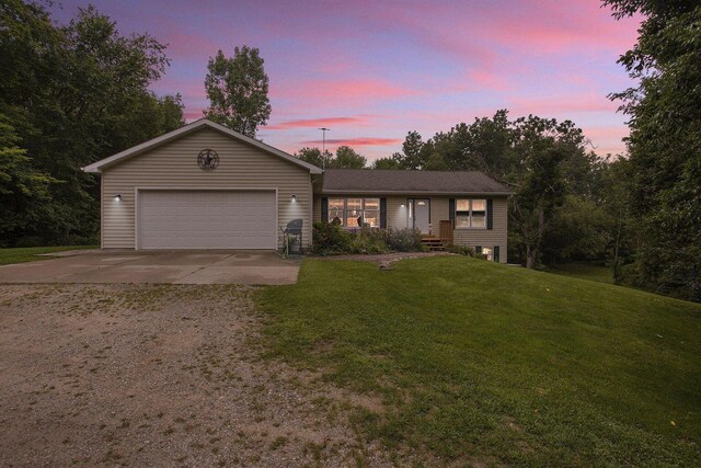 5293 Bartonville Rd, Belding, MI 48809 - ranch-style house featuring concrete driveway, an attached garage, and a front lawn
