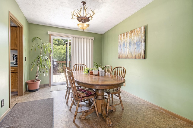 5293 Bartonville Rd, Belding, MI 48809 - dining area with a textured ceiling and a chandelier