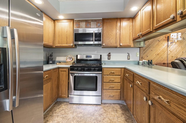 5293 Bartonville Rd, Belding, MI 48809 - kitchen featuring appliances with stainless steel finishes, brown cabinets, light countertops, and recessed lighting