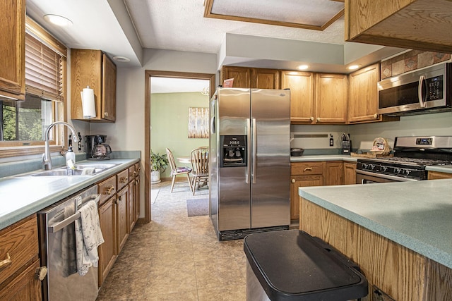 5293 Bartonville Rd, Belding, MI 48809 - kitchen with stainless steel appliances, light countertops, brown cabinets, a textured ceiling, and light floors